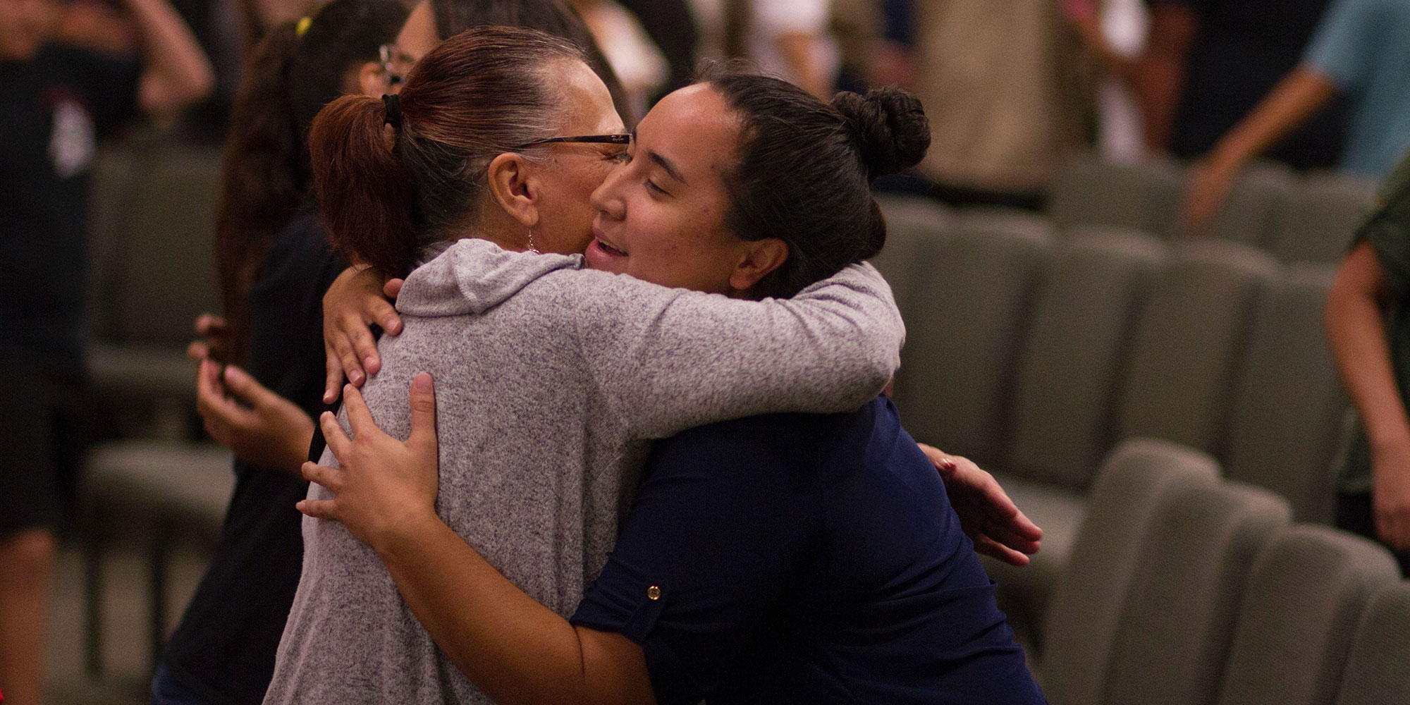 Two church members hugging